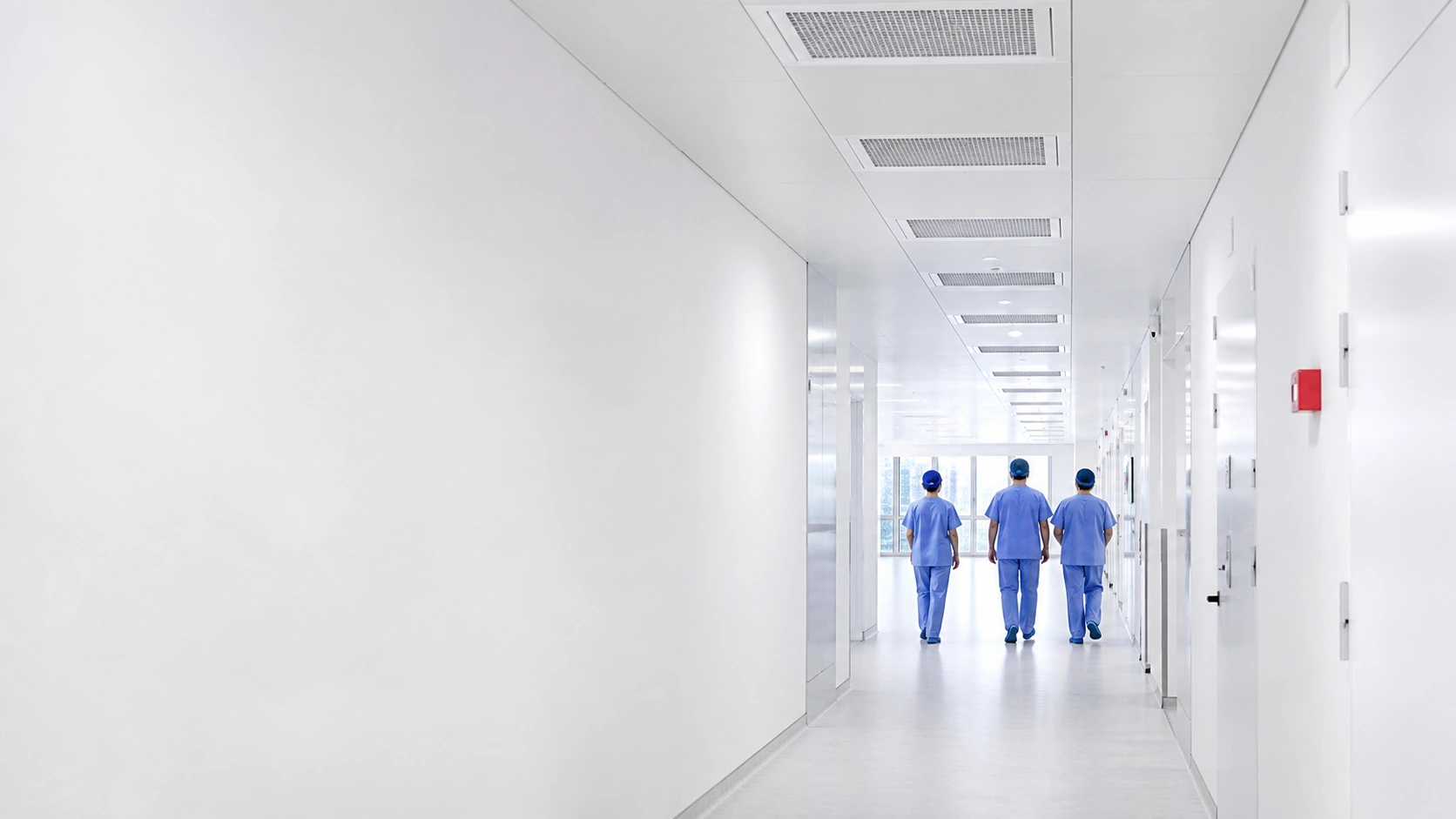 Clinical team walking through a bright hospital corridor